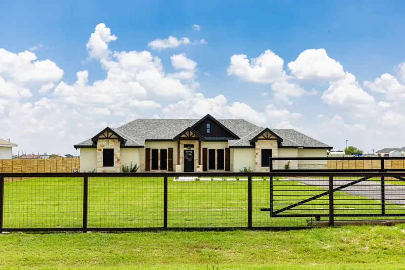Fenced stone home in Vista Ridge