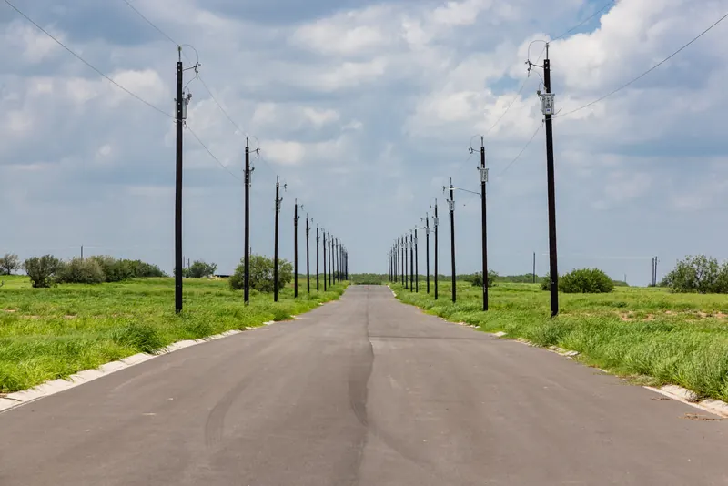Paved street with power lines in Vista Ridge Acres